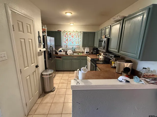 a room with lot of cabinets and appliances