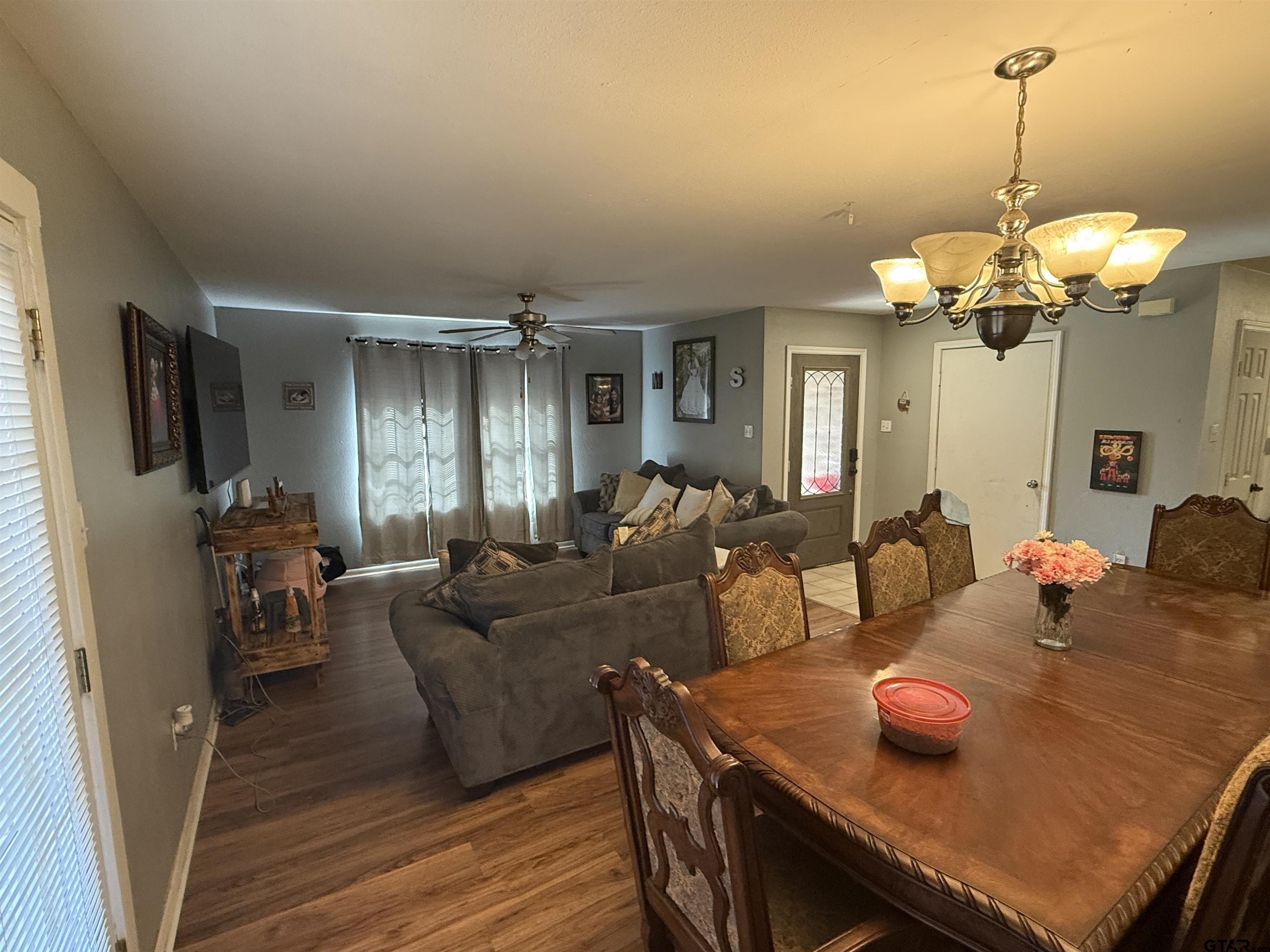 111 Jerome Court Rusk, TX 75785 - Photo 7 of 16 a living room with furniture dining table and a chandelier