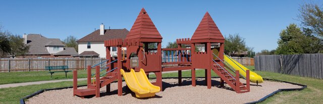 20724 Kearney Hill Road Pflugerville, TX 78660 - Photo 37 of 40 Outdoor play structure featuring two slides, multiple climbing access points, and a wood-chip ground cover