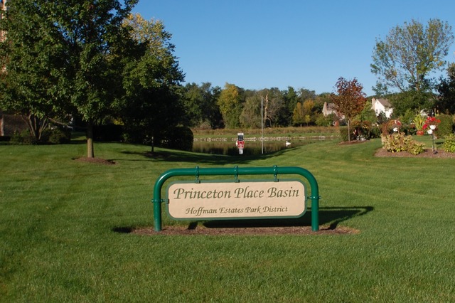 2103 Ivy Ridge Drive Hoffman Estates, IL 60192 - Photo 22 of 24 a sign board with a play ground in the back