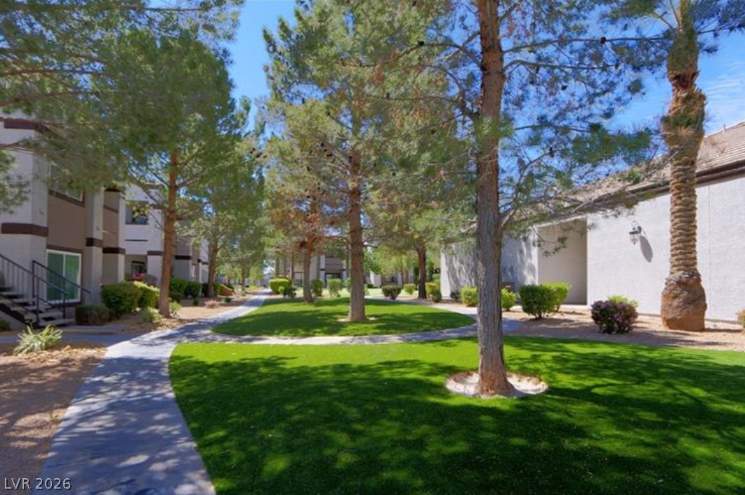 7255 West Sunset Road, Unit 2111 Las Vegas, NV 89113 - Photo 31 of 33 Manicured green spaces and paved walkways create an inviting community ambiance.