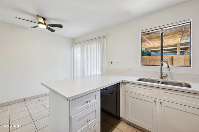a kitchen with a refrigerator sink and cabinets