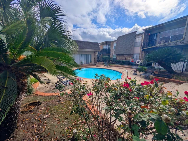 a view of a swimming pool with a yard