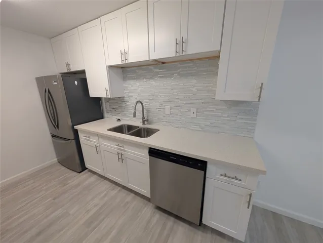 a kitchen with sink and cabinets