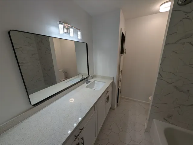 a bathroom with a double vanity sink and mirror