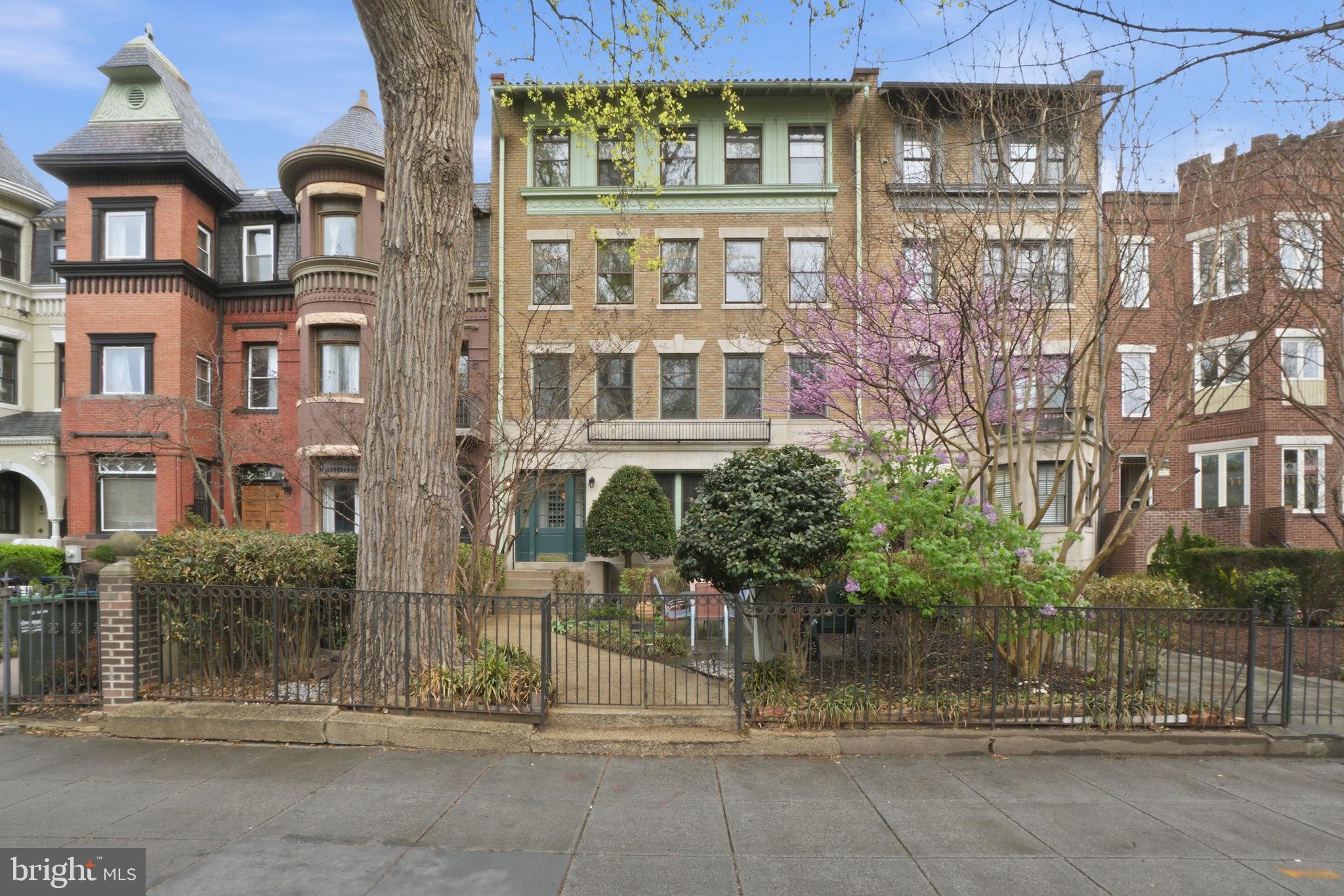 a view of a brick building next to a yard