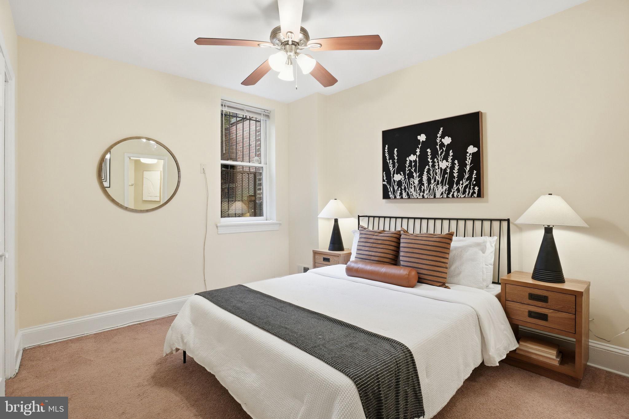 1835 16th Street Northwest, Unit 1 Washington, DC 20009 - Photo 12 of 27 a bedroom with a large bed and a chandelier