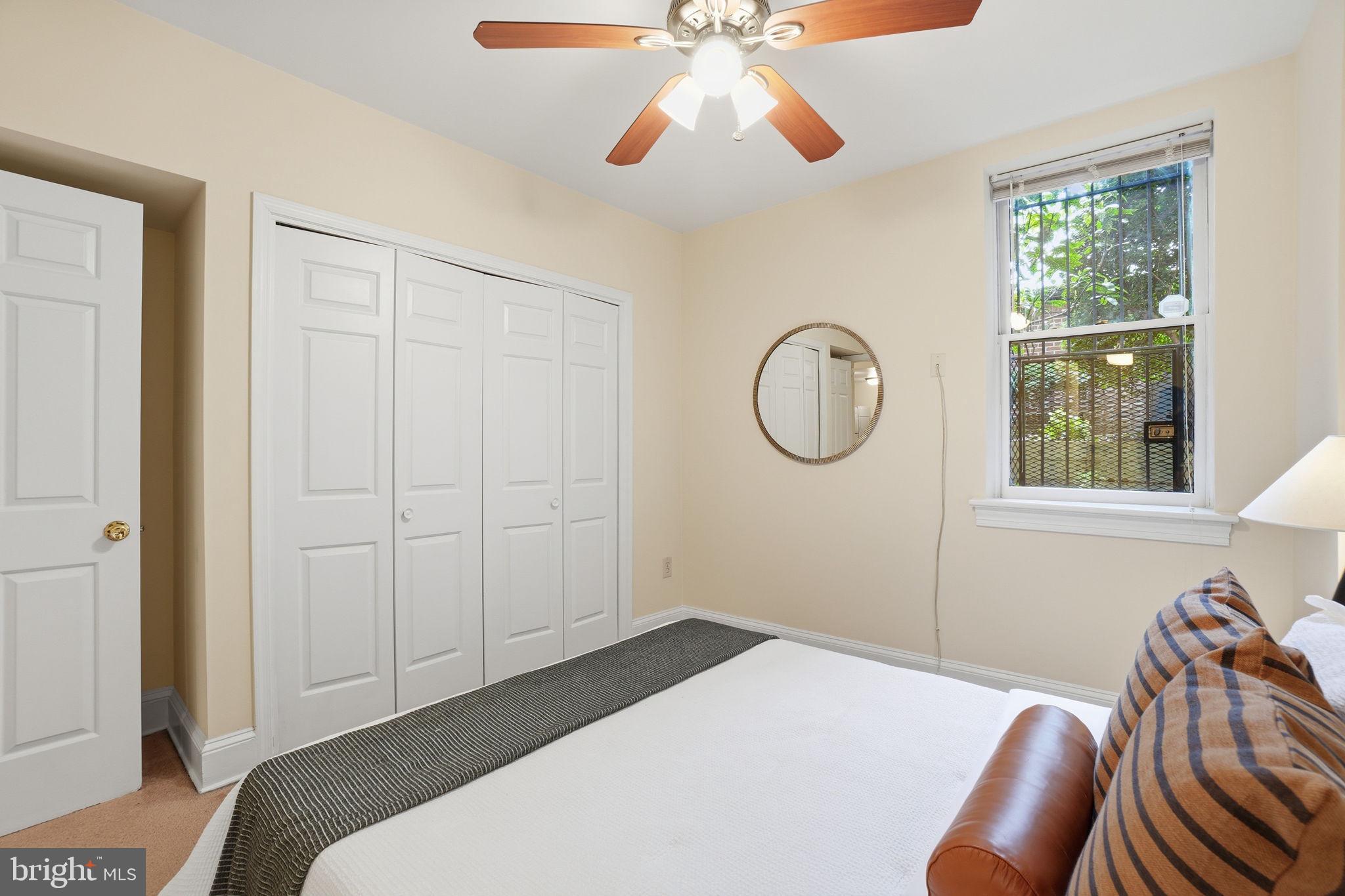 1835 16th Street Northwest, Unit 1 Washington, DC 20009 - Photo 13 of 27 a bedroom with a bed and a chandelier