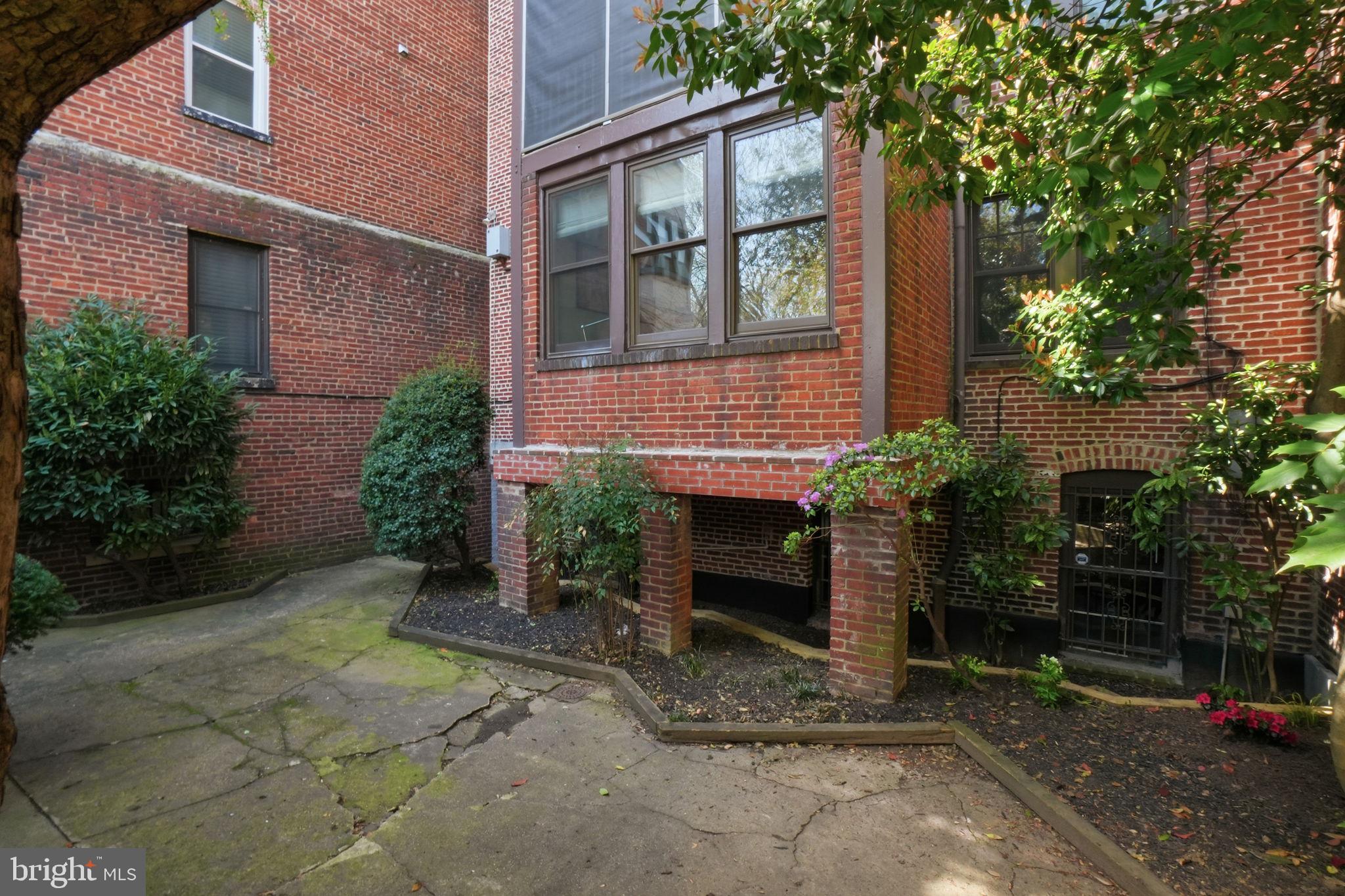 1835 16th Street Northwest, Unit 1 Washington, DC 20009 - Photo 27 of 27 a view of a brick house with a yard and large tree