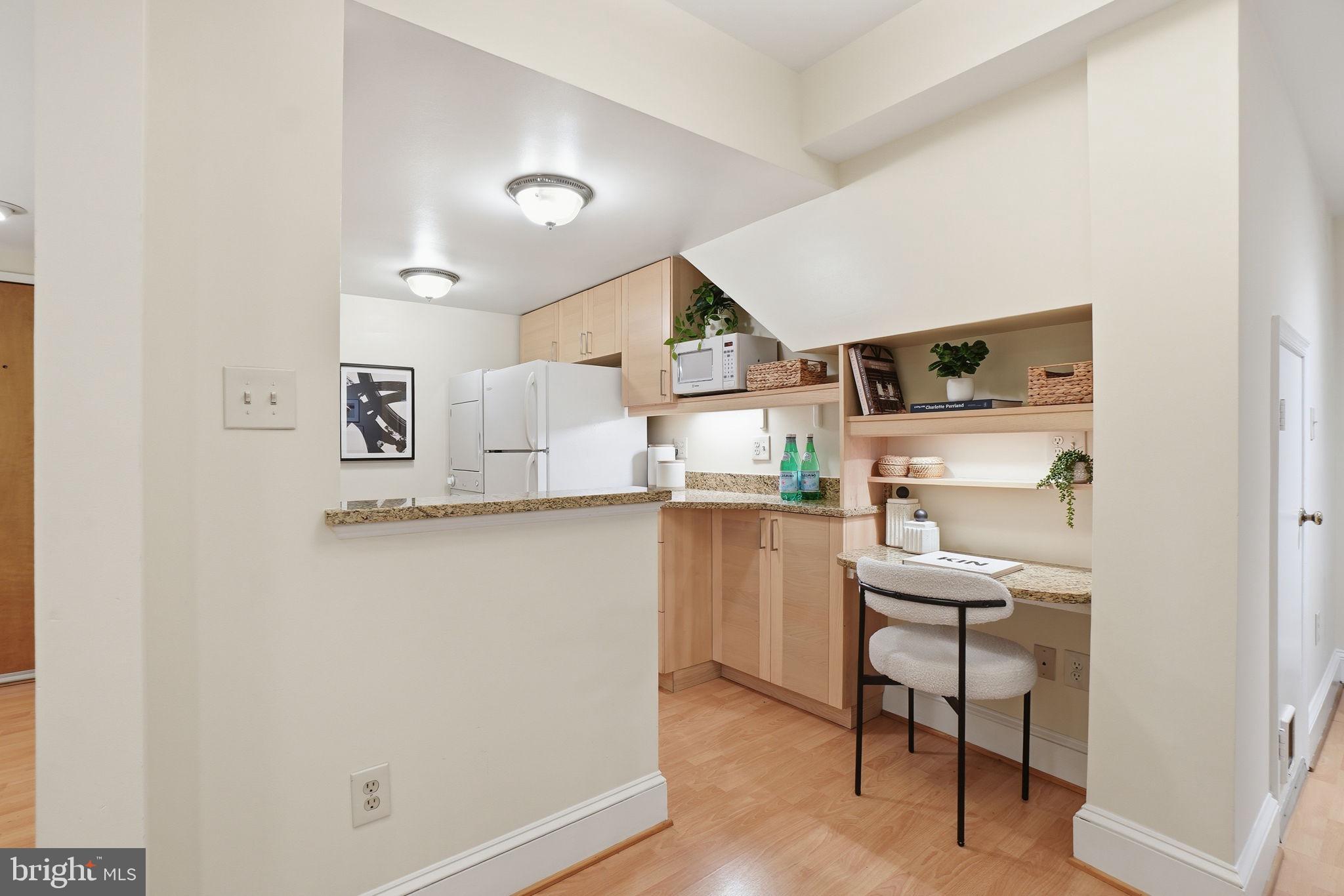 1835 16th Street Northwest, Unit 1 Washington, DC 20009 - Photo 7 of 27 a kitchen with stainless steel appliances a refrigerator a sink dishwasher and white cabinets with wooden floor