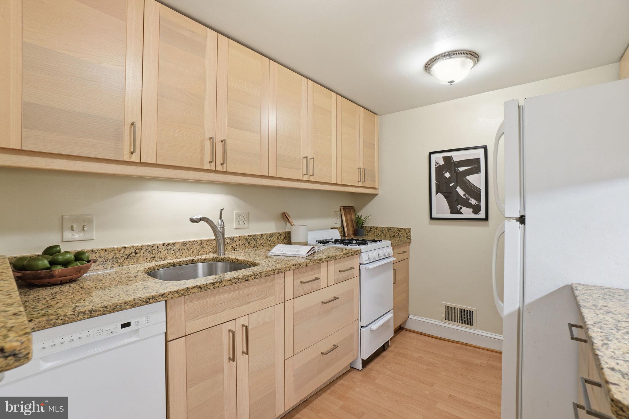 1835 16th Street Northwest, Unit 1 Washington, DC 20009 - Photo 8 of 27 a kitchen with stainless steel appliances granite countertop a sink and cabinets