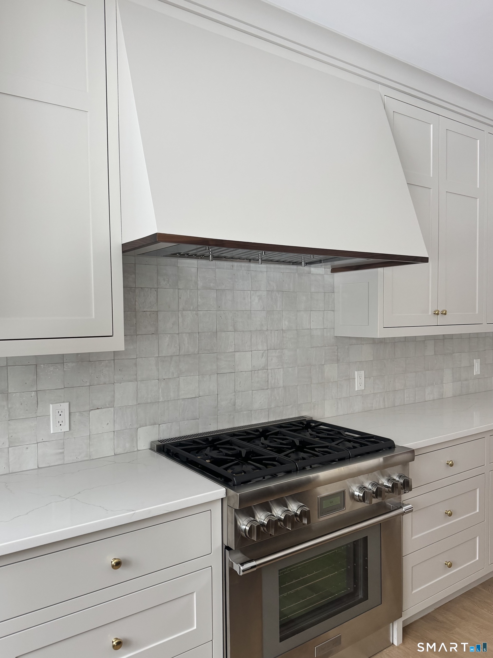 204 Glen Ridge Road Fairfield, CT 06825 - Photo 11 of 45 a stove top oven sitting inside of a kitchen