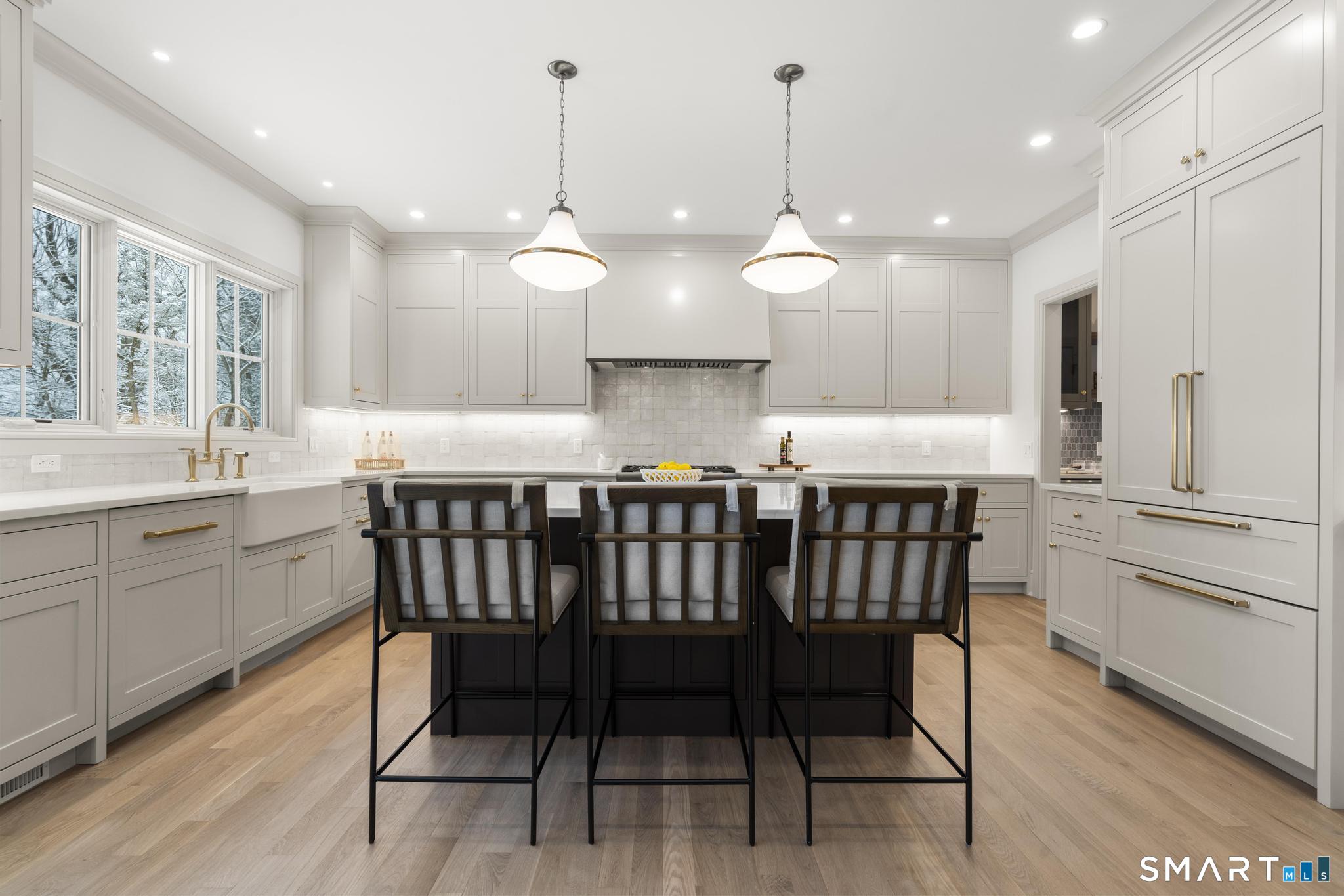 204 Glen Ridge Road Fairfield, CT 06825 - Photo 18 of 45 a kitchen with a dining table chairs sink and cabinets