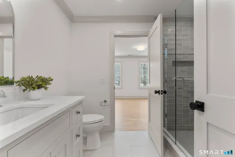 a bathroom with a sink vanity and a toilet