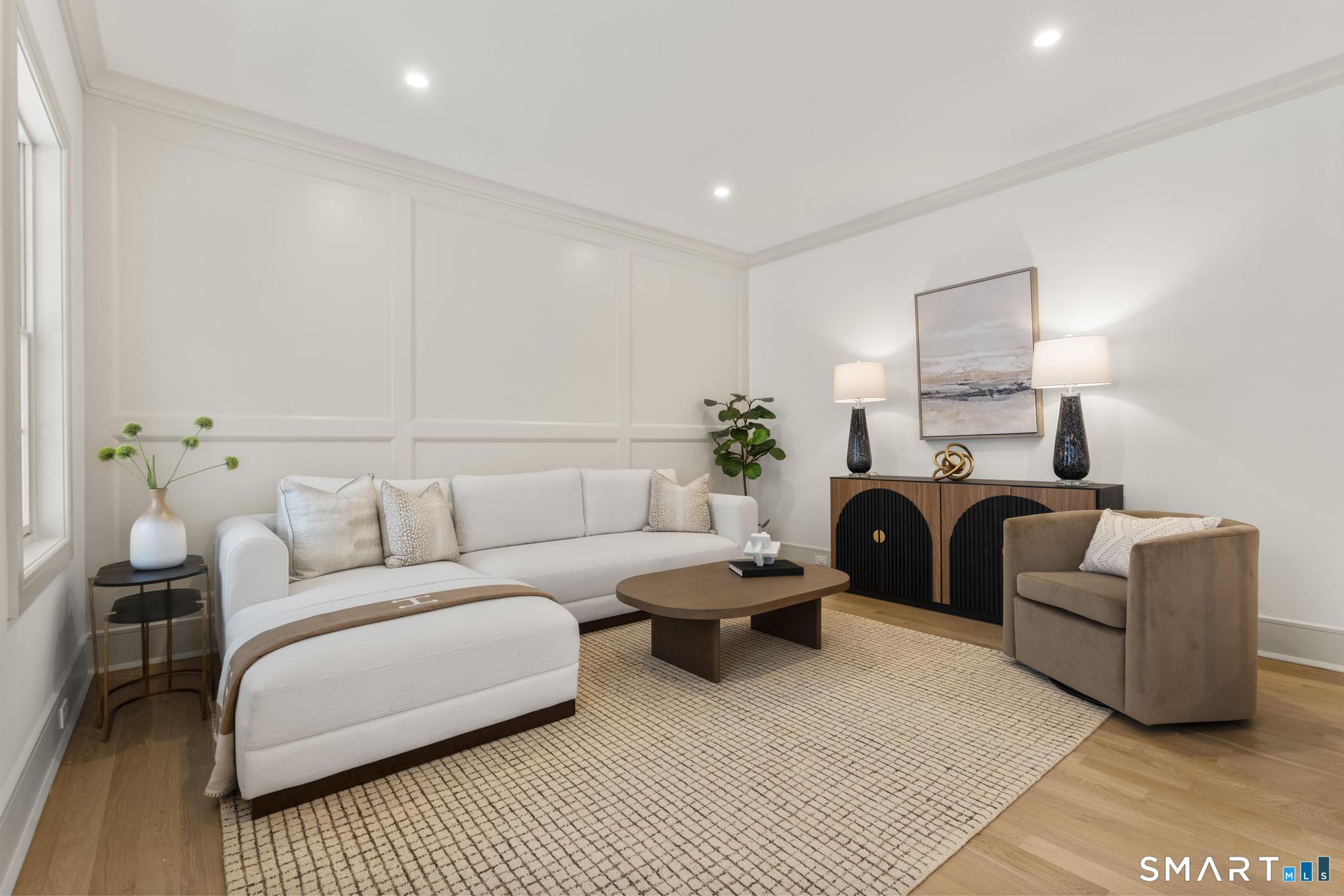204 Glen Ridge Road Fairfield, CT 06825 - Photo 29 of 45 a living room with furniture a lamp and a rug