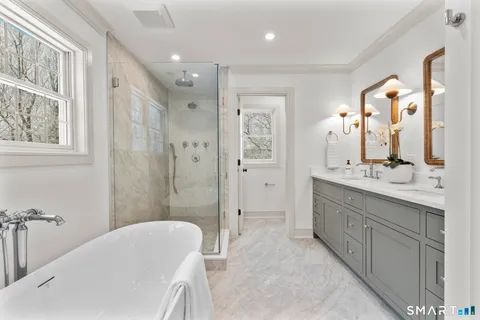 a bathroom with double vanity sinks and a mirror