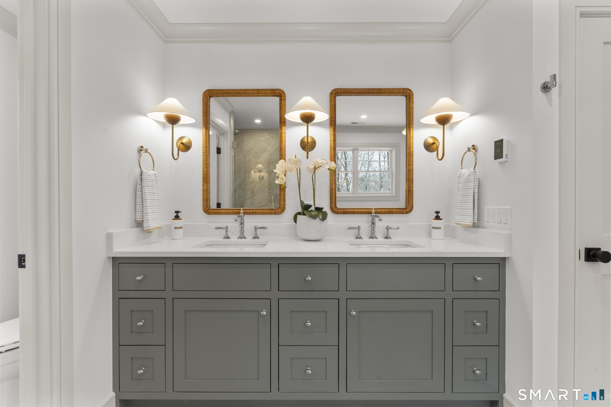 204 Glen Ridge Road Fairfield, CT 06825 - Photo 34 of 45 a bathroom with double vanity sinks and a mirror