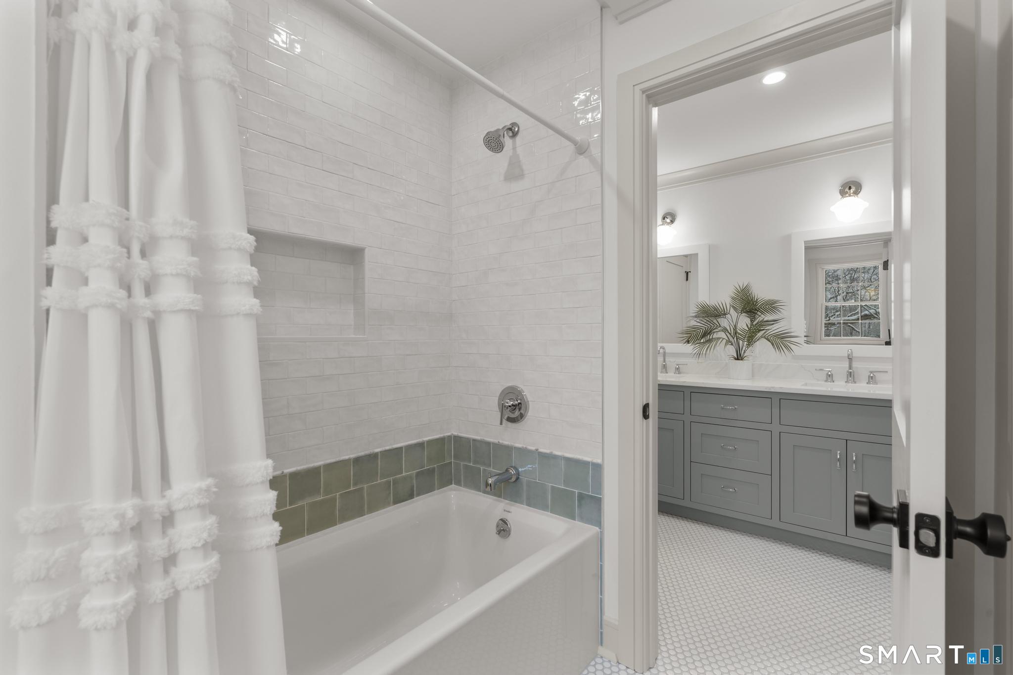 204 Glen Ridge Road Fairfield, CT 06825 - Photo 38 of 45 a bathroom with a bathtub sink vanity and mirror