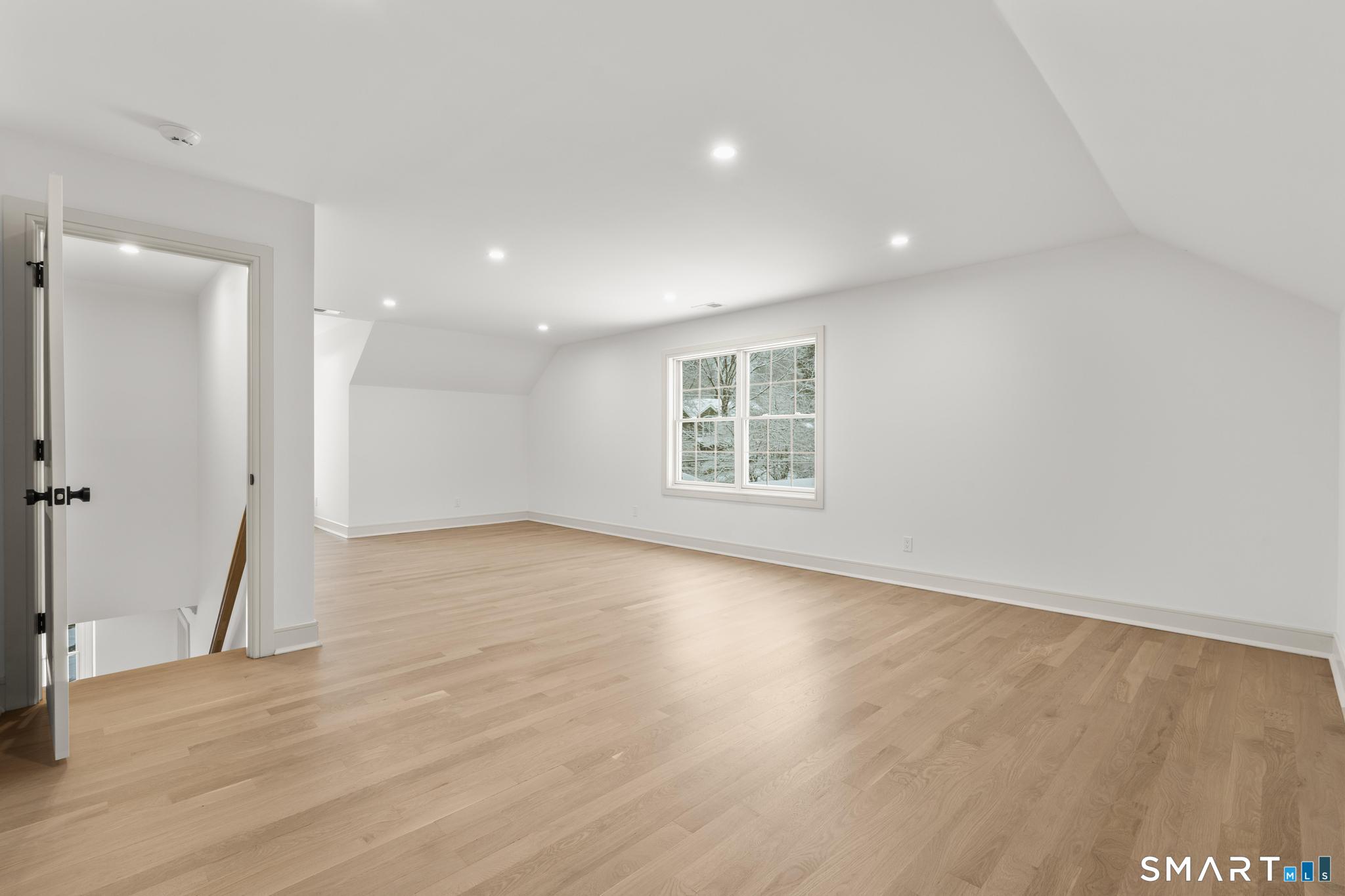 204 Glen Ridge Road Fairfield, CT 06825 - Photo 41 of 45 an empty room with wooden floor and windows