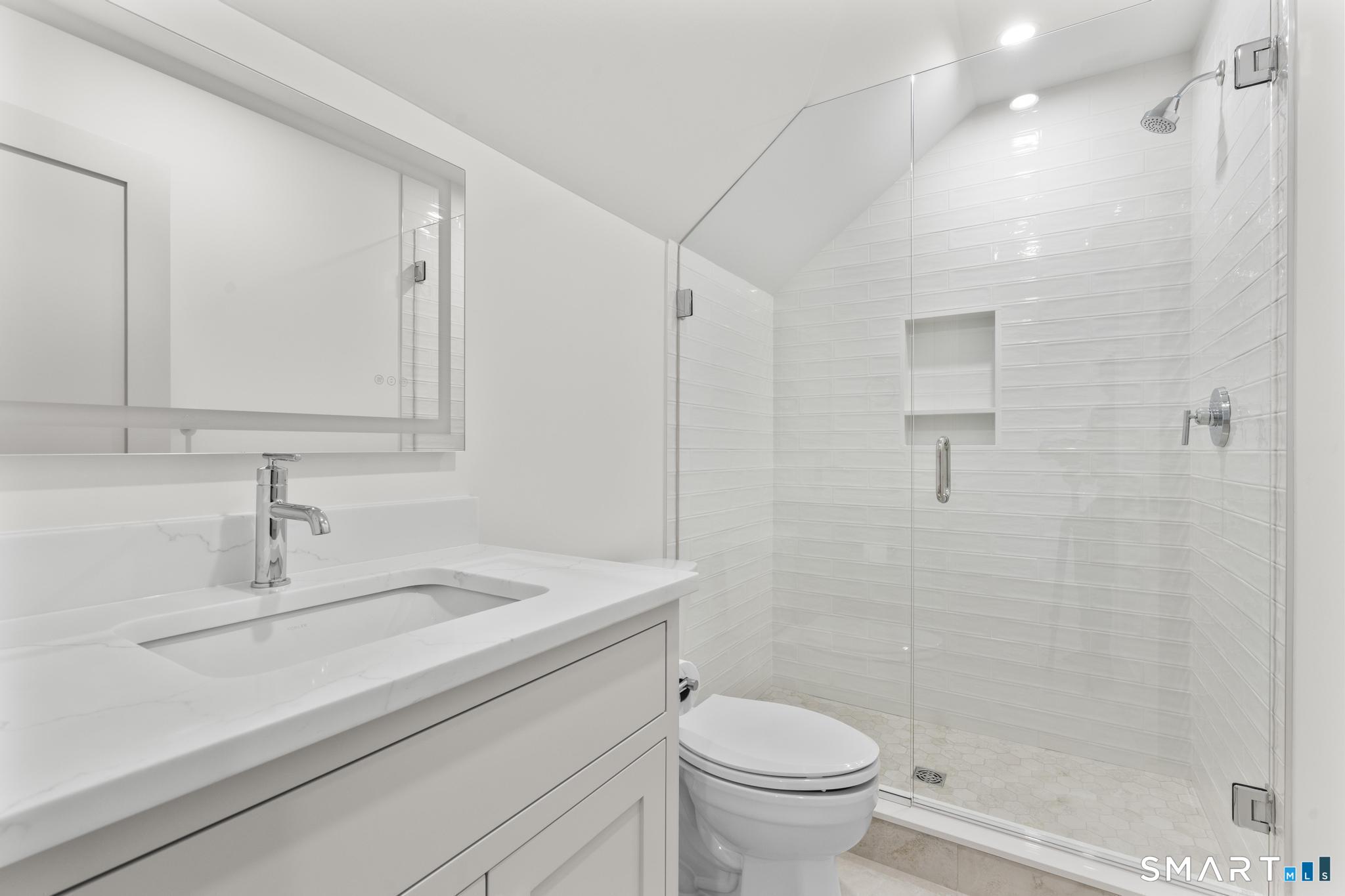 204 Glen Ridge Road Fairfield, CT 06825 - Photo 43 of 45 a bathroom with a sink a toilet and shower