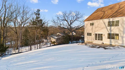 a view of a house with a snow in the yard