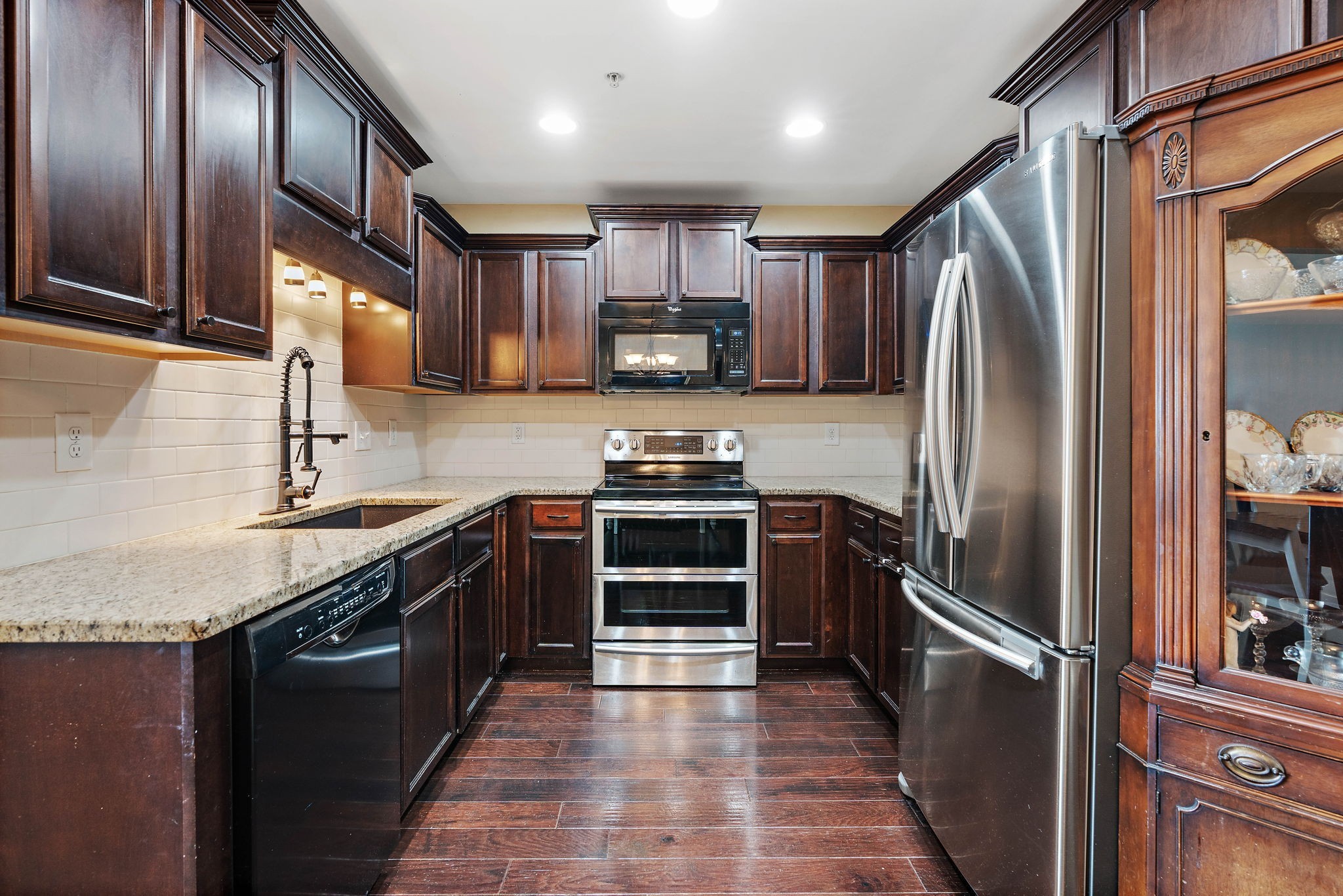 1071 Muna Court Spring Hill, TN 37174 - Photo 11 of 50 a kitchen with granite countertop stainless steel appliances and wooden cabinets