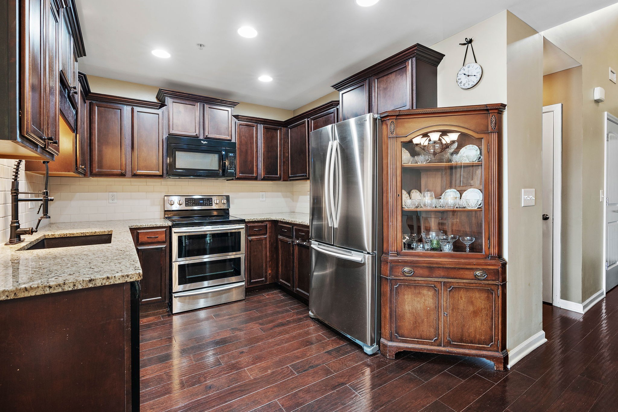 1071 Muna Court Spring Hill, TN 37174 - Photo 12 of 50 a kitchen with kitchen island granite countertop stainless steel appliances and wooden cabinets