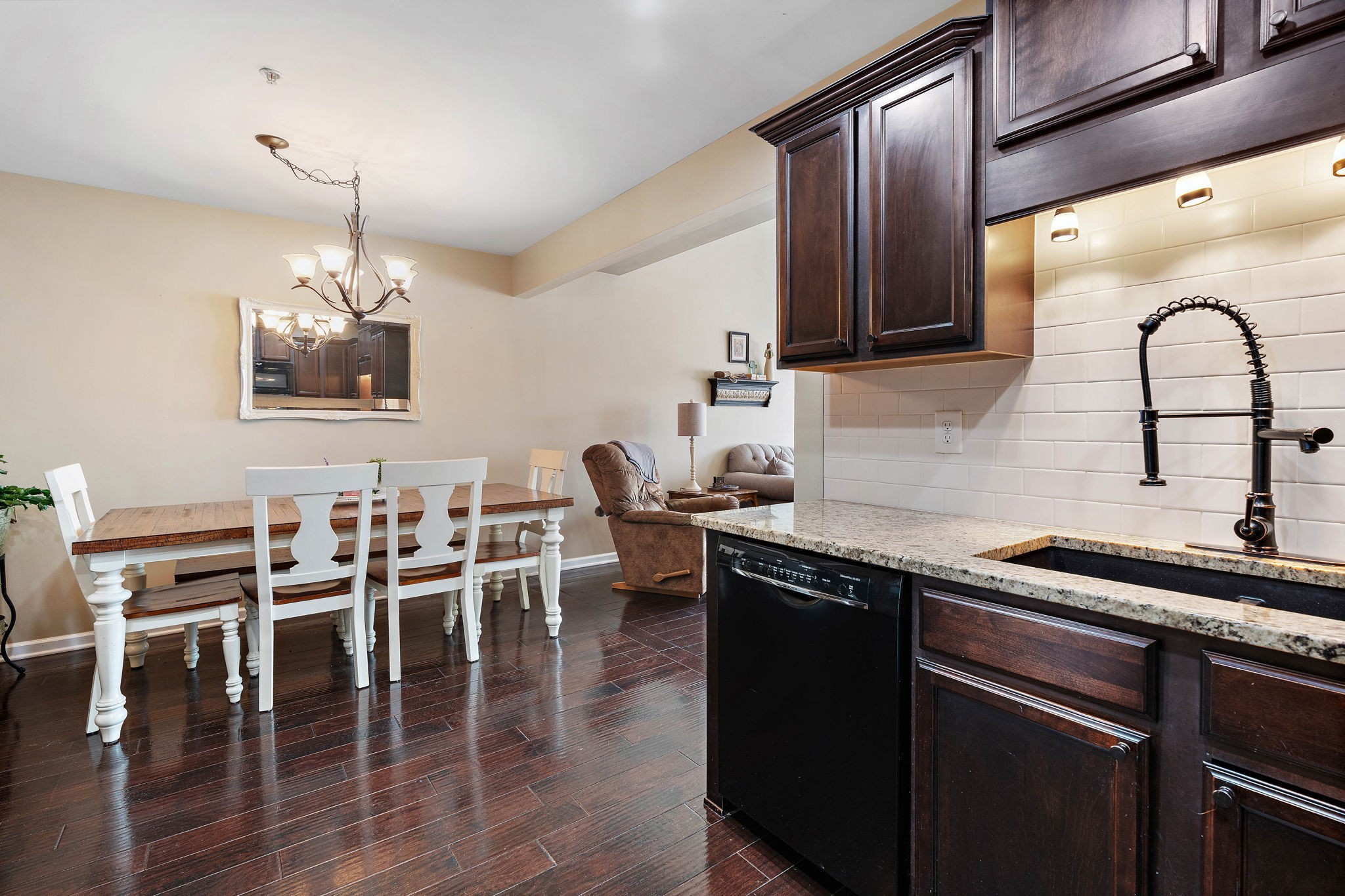 1071 Muna Court Spring Hill, TN 37174 - Photo 13 of 50 a kitchen with stainless steel appliances granite countertop a table chairs and a refrigerator