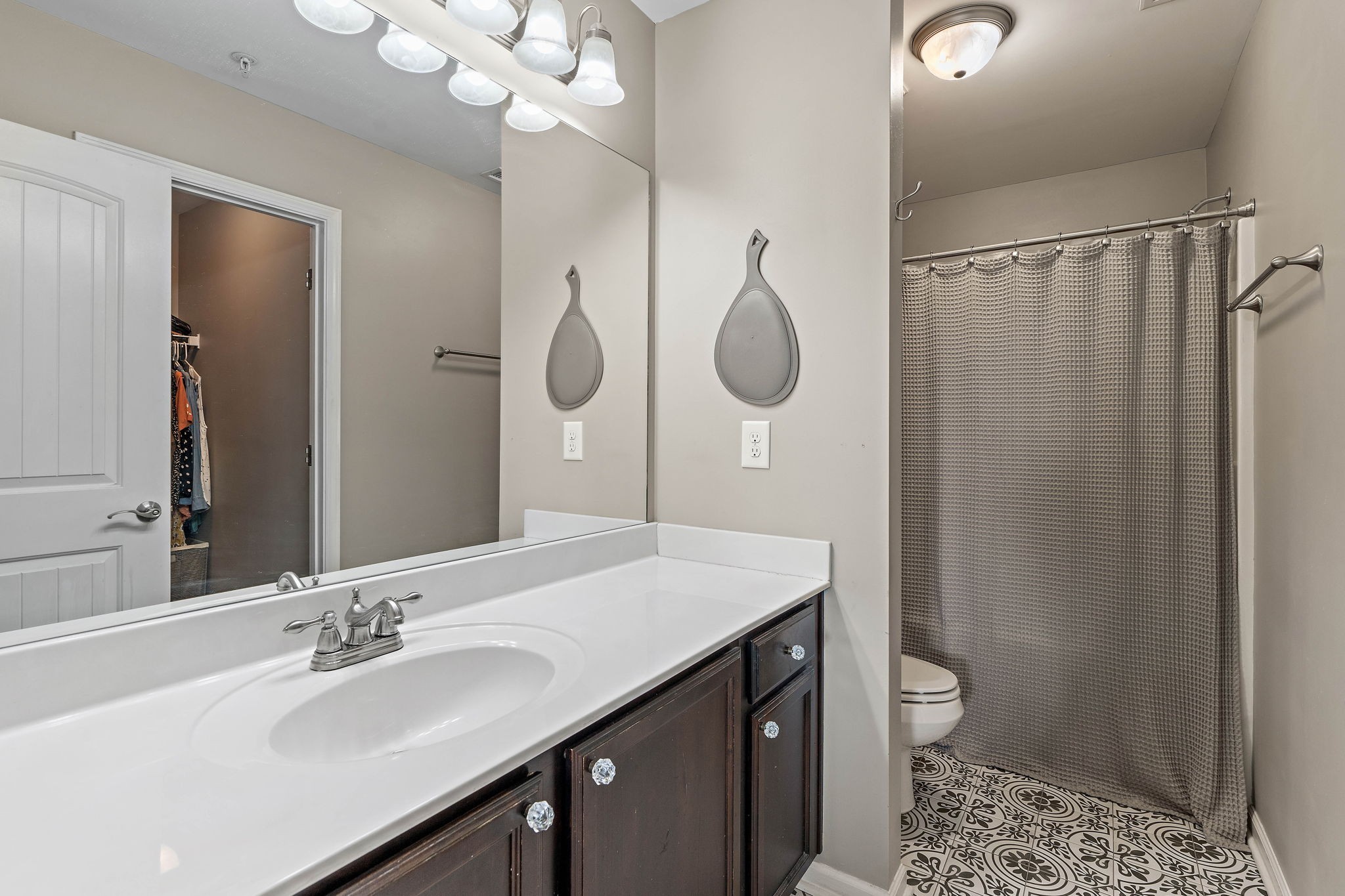 1071 Muna Court Spring Hill, TN 37174 - Photo 21 of 50 a bathroom with a sink a toilet a mirror and shower