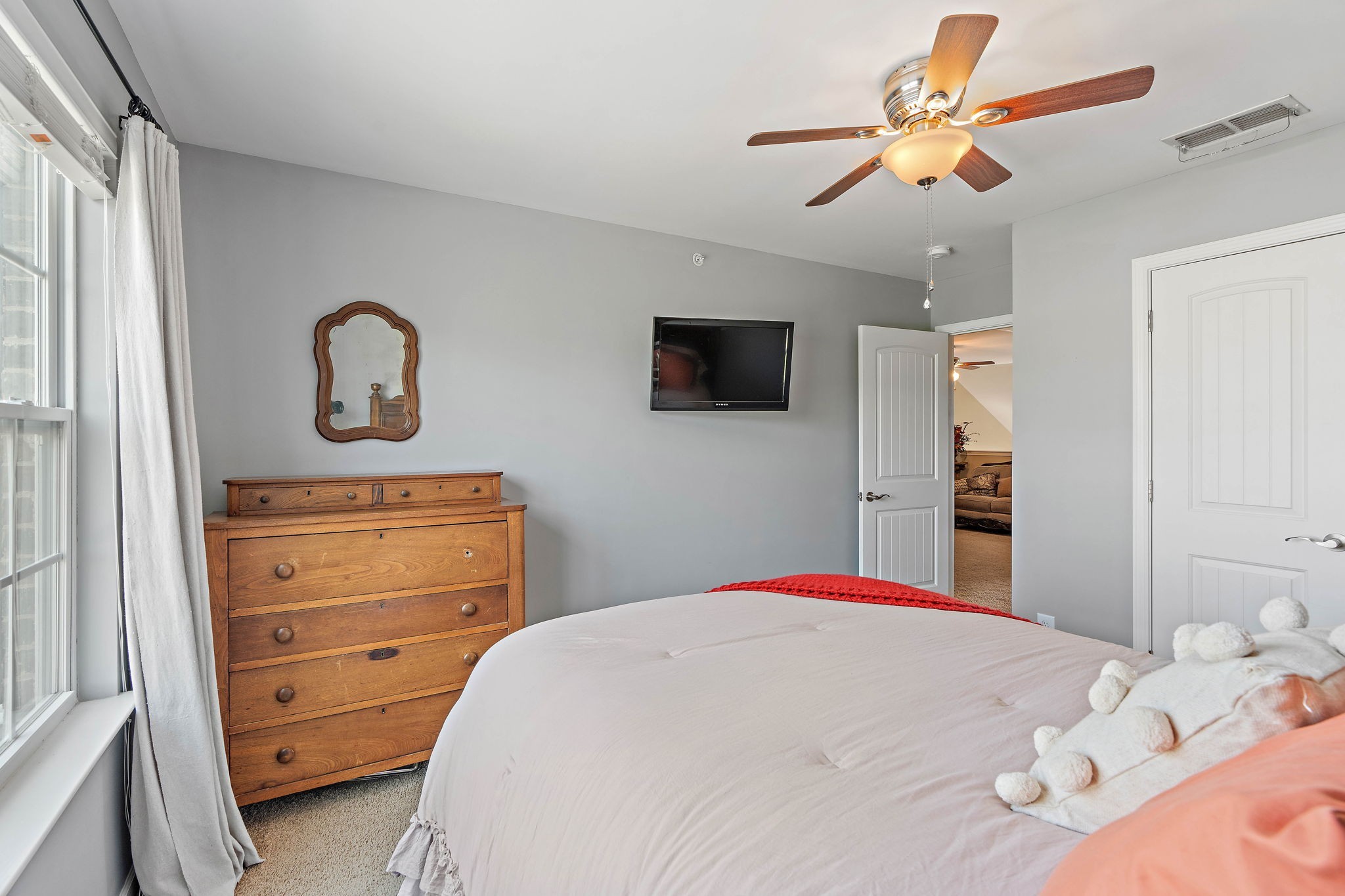 1071 Muna Court Spring Hill, TN 37174 - Photo 24 of 50 a bedroom with a bed and a flat tv screen on dresser