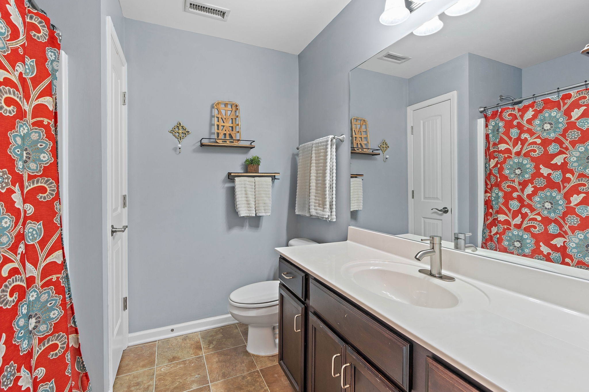 1071 Muna Court Spring Hill, TN 37174 - Photo 27 of 50 a bathroom with a sink and mirror with toilet