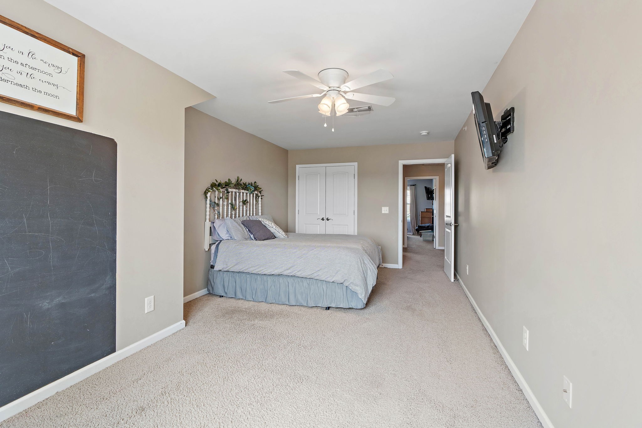 1071 Muna Court Spring Hill, TN 37174 - Photo 29 of 50 a bedroom with a large bed and a chandelier