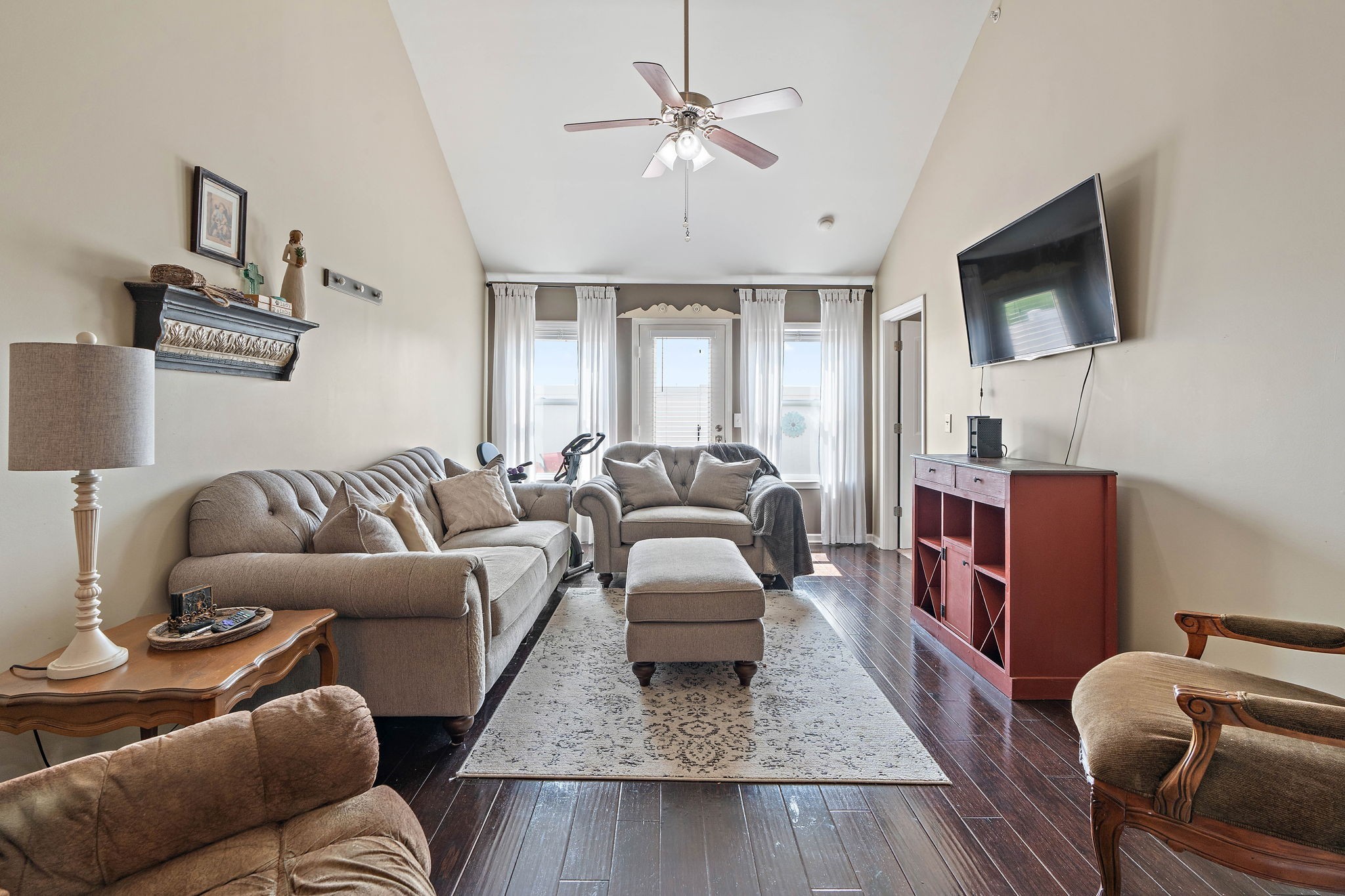 1071 Muna Court Spring Hill, TN 37174 - Photo 5 of 50 a living room with furniture a flat screen tv and a chandelier
