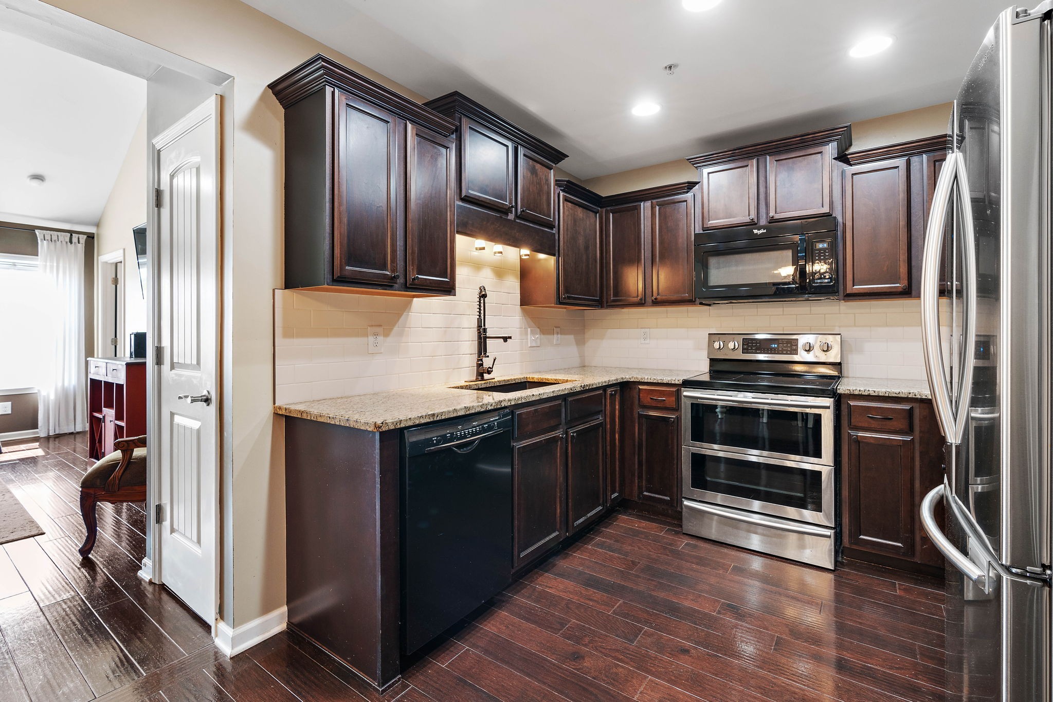 1071 Muna Court Spring Hill, TN 37174 - Photo 10 of 50 a kitchen with stainless steel appliances granite countertop a refrigerator stove and oven