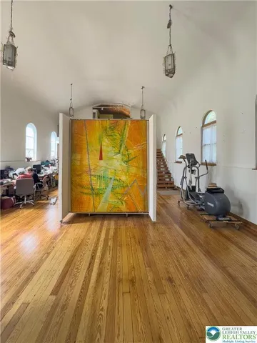 a view of a room with wooden floor