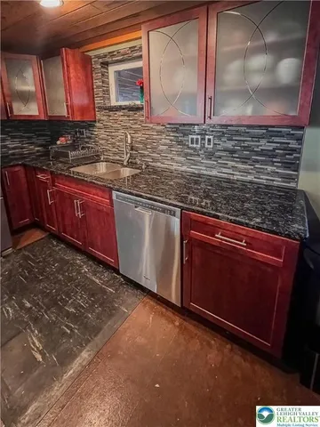 a kitchen with stainless steel appliances granite countertop a sink stove and cabinets