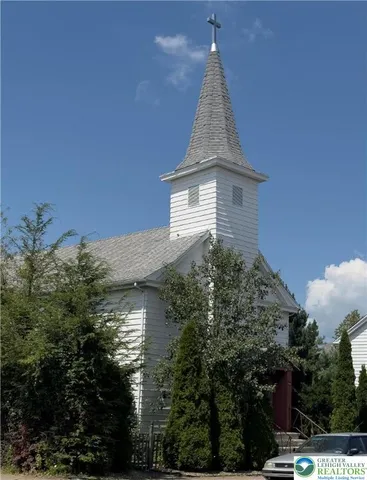 a aerial view of a house with a yard and potted plants