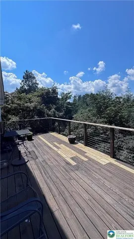 a view of balcony with wooden floor and fence