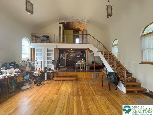 a view of hall way with furniture and floor to ceiling window