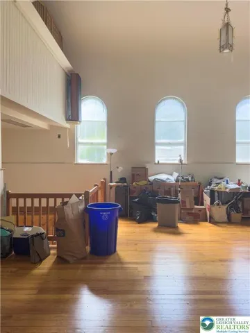 a living room with furniture window and a wooden floor