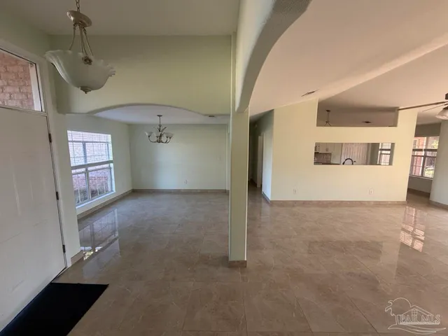 a view of a big room with windows and cabinet