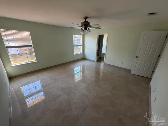an empty room with windows and closet