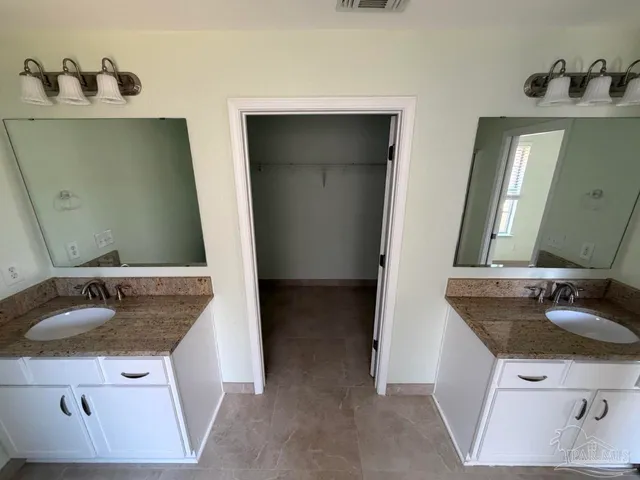 a bathroom with sink and mirror