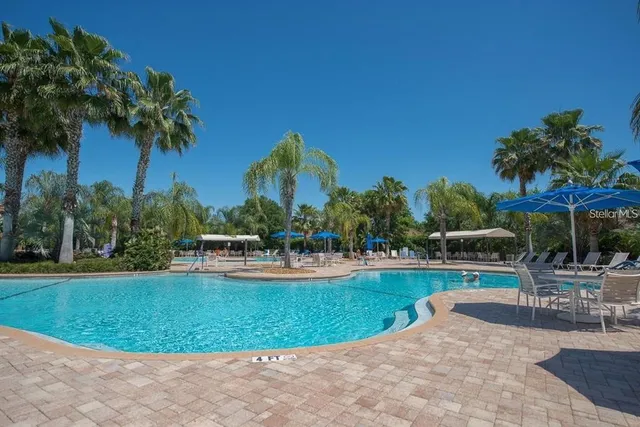 a view of a swimming pool with a table and chairs