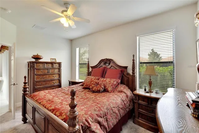 a bedroom with a large bed and a chandelier