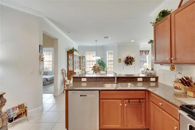 a kitchen with stainless steel appliances granite countertop a sink and cabinets