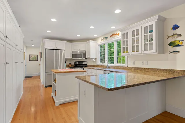 a kitchen with a refrigerator a stove a sink and a window