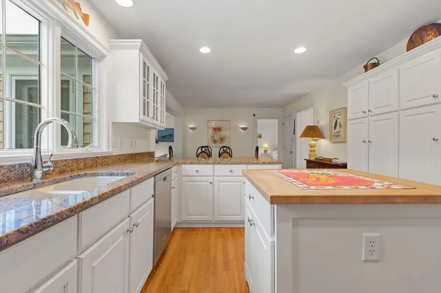 a view of a a dining room with furniture window and wooden floor