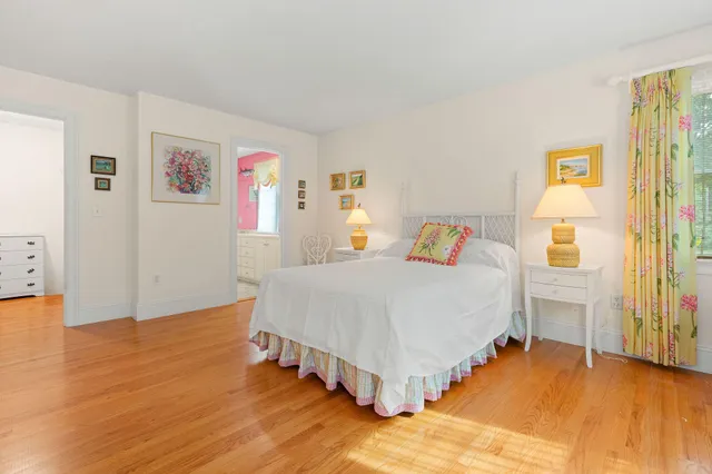 a bathroom with a sink a large mirror and a window