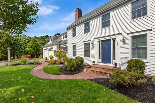 a front view of a house with garden